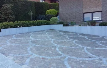 14 Pavés 8-10 grès Kandla posés en éventail avec ligne décorative pierre bleue et palissades pierre bleue